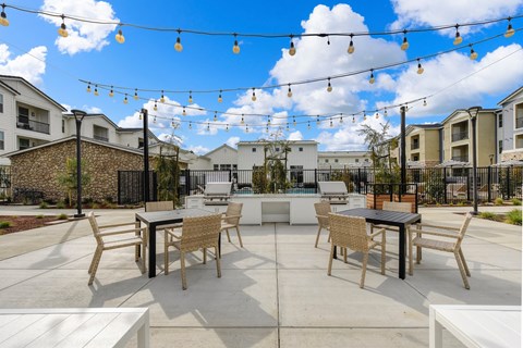 Outdoor seating area overlooking the community BBQ area, Chairs and Hanging Lights